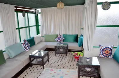 a living room with a couch with pillows on it at Riad Dar Salma in Fès