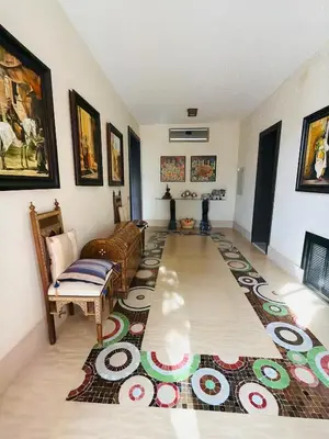 a living room with a couch and a rug at Villa Fatima, Route de Fès in Oulad Akkou