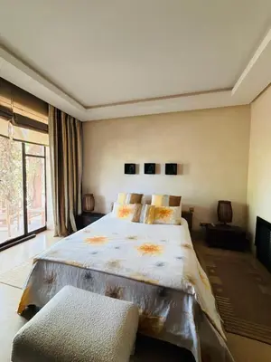 a bedroom with a large bed and a large window at Villa Fatima, Route de Fès in Oulad Akkou