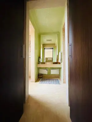 an empty hallway with a mirror in a bathroom at Villa Fatima, Route de Fès in Oulad Akkou