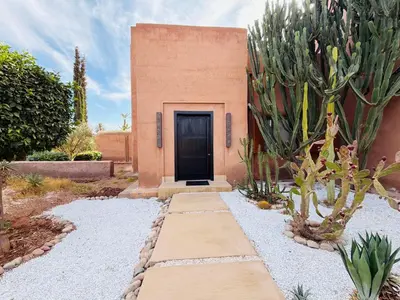 a door to a building with a cactus at Villa Fatima, Route de Fès in Oulad Akkou