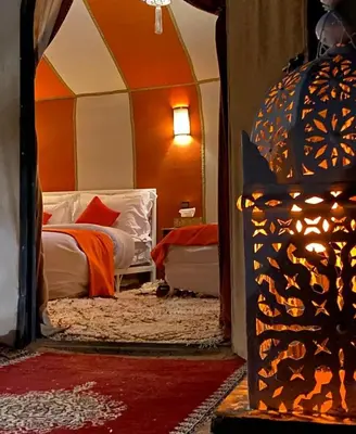 a bedroom with a bed in a tent at Merzouga Boho Camp in Merzouga