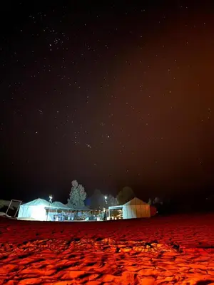 a night time view of a building in the desert at Merzouga Sahara Nights Tents in Merzouga
