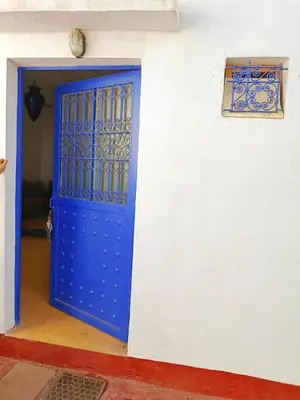a blue door in a white wall with a window at Authentic Berber Home Retreat Ourika Valley in Aghmat