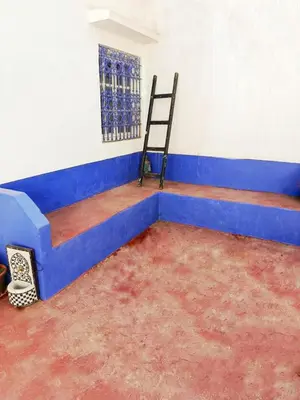 a room with a blue bed and a chair in it at Authentic Berber Home Retreat Ourika Valley in Aghmat
