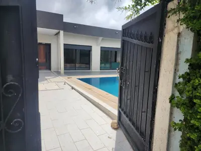 an open gate to a house with a swimming pool at Villa Luxe Fès avec Piscine & Spa, proche aéroport, Private Hammam in Fès