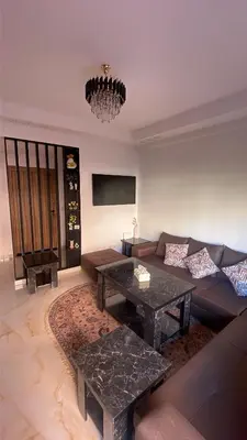 a living room with a couch and a table at Premium village marrakech in Ville Nouvelle