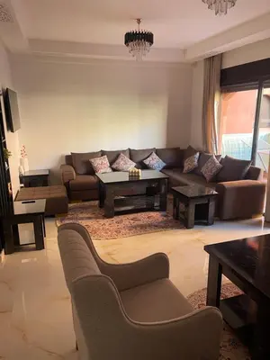 a living room with a couch and a table at Premium village marrakech in Ville Nouvelle