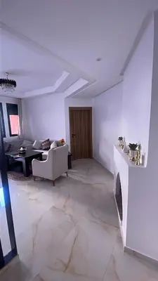 a living room with a couch and a table at Premium village marrakech in Ville Nouvelle