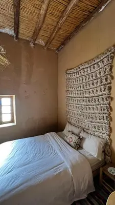 a bedroom with a bed in a room at Merzouga Nomad House in Merzouga