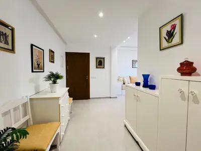 a living room with white cabinets and a table at Colina Smir par Immo Marina Vacances de Rêve B1-10 in Oulad Akkou