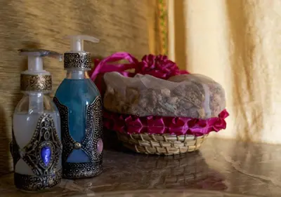 two bottles of soap and a basket on a table at Sahara Relax Camps in Zagora