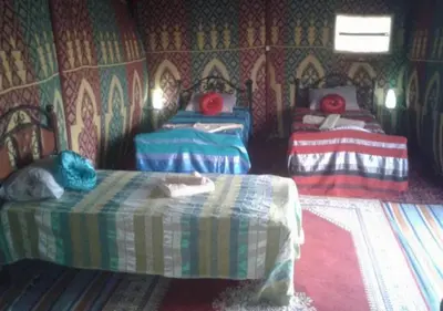 a room with three beds in a room with at Sahara Relax Camps in Zagora