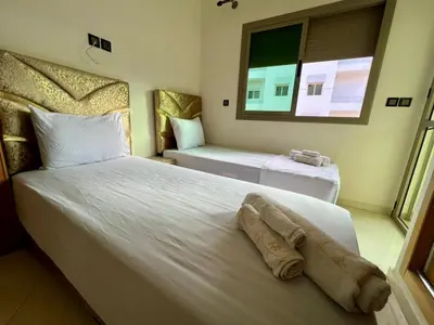 a hotel room with two beds and a window at Appart Hotel Noor Fes - Family & Traveler Apartments in Fès