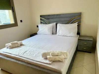 a bedroom with a bed with two towels on it at Appart Hotel Noor Fes - Family & Traveler Apartments in Fès