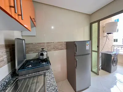 a kitchen with a stove and a refrigerator at Appart Hotel Noor Fes - Family & Traveler Apartments in Fès