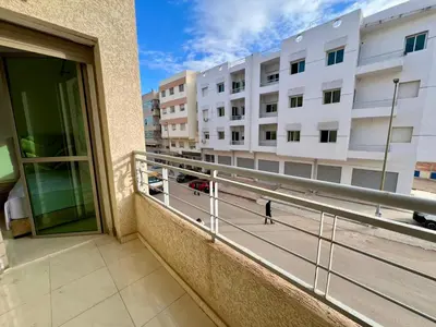 a person walking on a balcony of a building at Appart Hotel Noor Fes - Family & Traveler Apartments in Fès