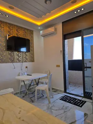 a dining room with a table and a tv on the wall at Dar aya comfort