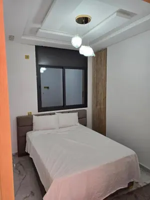 a bedroom with a large bed with a window at Dar aya comfort