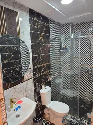 a bathroom with a toilet and a shower and a sink at Dar aya comfort