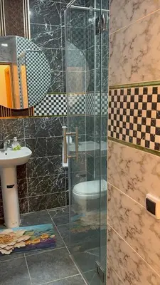 a bathroom with a glass shower and a sink at Dar aya comfort