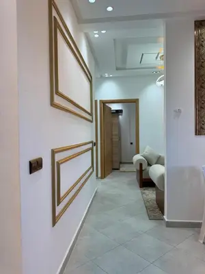 a hallway with two framed pictures on the wall at Dar aya comfort