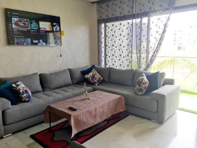 a living room with a couch and a coffee table at Confort in Fès