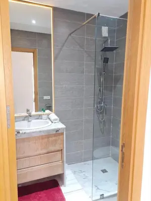 a bathroom with a shower with a sink and a shower at Confort in Fès