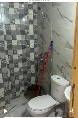 a bathroom with a toilet and a mop at فاس in Fès