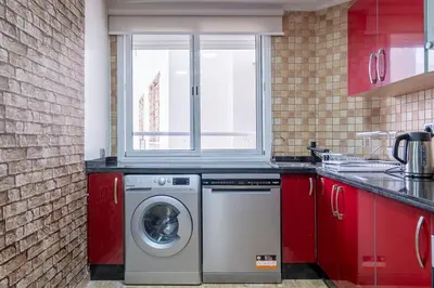 a kitchen with a washing machine and a window at Aquarium et Luxe Central in Oulad Akkou