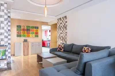 a living room with a couch and a table at Aquarium et Luxe Central in Oulad Akkou