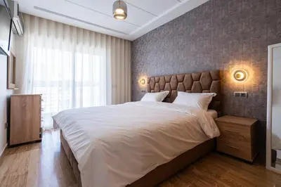 a bedroom with a large bed and a large window at Aquarium et Luxe Central in Oulad Akkou