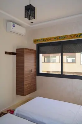 a bedroom with a bed and a window at appartement nassime fes 4 chambre in Fès