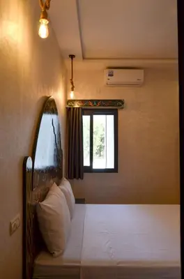 a bedroom with a bed and a window at appartement nassime fes 4 chambre in Fès