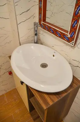 a white sink in a bathroom with a mirror at appartement nassime fes 4 chambre in Fès