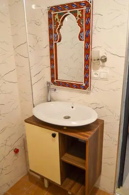 a bathroom with a sink and a mirror on the wall at appartement nassime fes 4 chambre in Fès