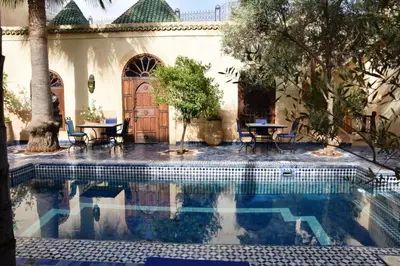 a swimming pool in front of a house at Chambre topaze - Riad lotus bleu in Fès