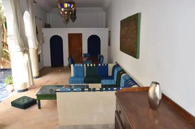 a living room with a couch and a table at Chambre topaze - Riad lotus bleu in Fès