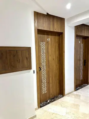 a pair of wooden doors in a room at Garden View- Gueliz-Majorelle appartement 2 chambres- Wifi et piscines in Oulad Akkou