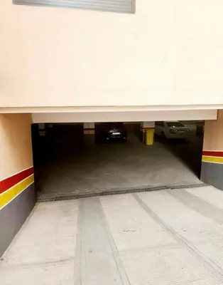 a garage with a car parked under a building at Garden View- Gueliz-Majorelle appartement 2 chambres- Wifi et piscines in Oulad Akkou