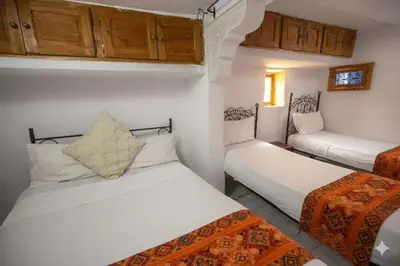 two beds in a room with wooden cabinets at Fes Medina Vibes Hostel in Fès