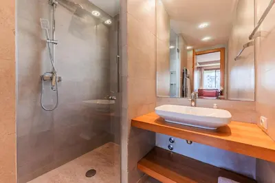a bathroom with a sink and a shower at Riva Molière Parking Elegance in Oulad Akkou