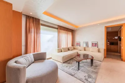 a living room with a couch and a table at Riva Molière Parking Elegance in Oulad Akkou