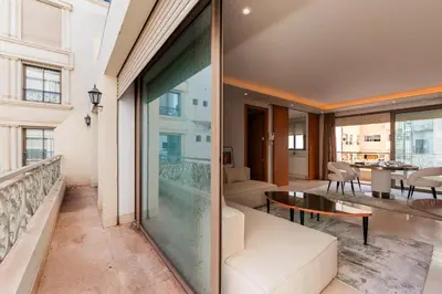a living room with a couch and a table at Riva Molière Parking Elegance in Oulad Akkou