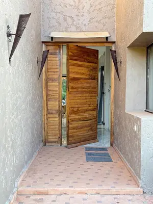 a wooden door leading into a house at Villa Five Collection - Private Luxury & Heated Pool