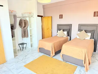 a room with two beds and a closet at Villa Five Collection - Private Luxury & Heated Pool