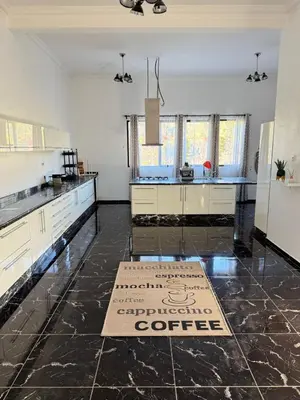 a large kitchen with a coffee sign on the floor at Villa Five Collection - Private Luxury & Heated Pool