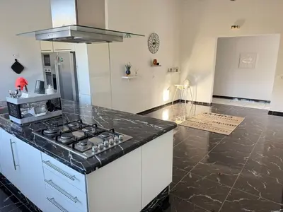 a kitchen with a stove and a counter top at Villa Five Collection - Private Luxury & Heated Pool