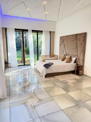 a bedroom with a bed and a tiled floor at Villa Five Collection - Private Luxury & Heated Pool