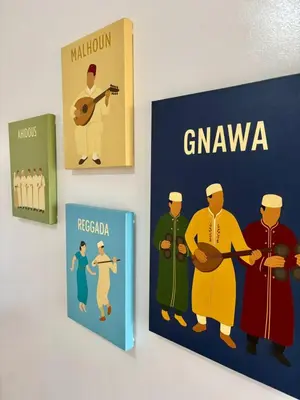three books are hanging on a wall at Le cocon d'Asilah Mer et Confort in Oulad Akkou